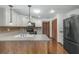 Modern kitchen featuring black appliances and wood flooring at 4612 Glenbrooke Dr, Sarasota, FL 34243