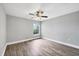 Bright bedroom with wood-look floors and ceiling fan at 8803 Manor Loop # 204, Lakewood Ranch, FL 34202