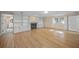 Living room with hardwood floors, fireplace, and built-in shelving at 3556 E Forest Lake Dr, Sarasota, FL 34232