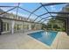 Inviting pool and patio area with a screened enclosure at 3556 E Forest Lake Dr, Sarasota, FL 34232