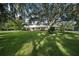 A charming ranch-style home nestled on a spacious lot with mature trees at 3556 E Forest Lake Dr, Sarasota, FL 34232