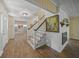 Bright entryway with hardwood floors, fireplace, and staircase leading upstairs at 3556 E Forest Lake Dr, Sarasota, FL 34232