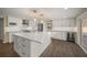 Modern kitchen featuring a large island, stainless steel appliances, and white shaker cabinets at 3556 E Forest Lake Dr, Sarasota, FL 34232