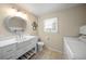 Bright bathroom with white vanity and laundry area at 3556 E Forest Lake Dr, Sarasota, FL 34232