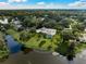 Aerial view of a home with a pool, situated on a waterfront lot in a serene setting at 3556 E Forest Lake Dr, Sarasota, FL 34232
