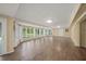 Spacious Gathering room with hardwood floors and large windows at 3556 E Forest Lake Dr, Sarasota, FL 34232