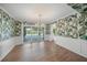 Bright dining room with leafy wallpaper and pool view at 3556 E Forest Lake Dr, Sarasota, FL 34232