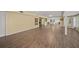 Large living room with hardwood floors and views into the kitchen at 3556 E Forest Lake Dr, Sarasota, FL 34232
