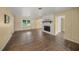 Living room featuring hardwood floors, fireplace and large window at 3556 E Forest Lake Dr, Sarasota, FL 34232
