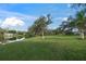 Large backyard with a pond view and lush grass at 3556 E Forest Lake Dr, Sarasota, FL 34232