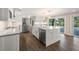 Updated kitchen with white cabinets, stainless steel appliances and island at 3556 E Forest Lake Dr, Sarasota, FL 34232
