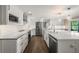 Modern kitchen with white cabinets, stainless steel appliances, and a large island at 3556 E Forest Lake Dr, Sarasota, FL 34232