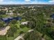 An aerial view of a property that includes a house and a large backyard at 3556 E Forest Lake Dr, Sarasota, FL 34232