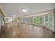 Spacious Gathering room with hardwood floors and large windows overlooking the pool at 3556 E Forest Lake Dr, Sarasota, FL 34232