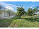 Spacious backyard with lush lawn and screened patio at 3556 E Forest Lake Dr, Sarasota, FL 34232