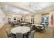 Large community room with multiple tables and chairs at 13180 Ipolita St, Venice, FL 34293