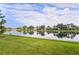 Stunning lakefront property with lush green landscaping and beautiful homes reflecting in the water at 13180 Ipolita St, Venice, FL 34293