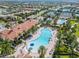 Aerial view of community pool and clubhouse with surrounding homes at 13180 Ipolita St, Venice, FL 34293
