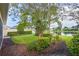 Landscaped backyard with pond view and lush greenery at 13180 Ipolita St, Venice, FL 34293