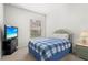 Bedroom with blue plaid bedding and a view of the backyard at 13180 Ipolita St, Venice, FL 34293