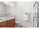 Clean bathroom with shower and wood vanity at 13180 Ipolita St, Venice, FL 34293