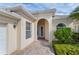 Inviting home exterior with a paved walkway, arched entryway, and lush landscaping at 13180 Ipolita St, Venice, FL 34293