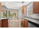 Kitchen with ample counter space, wood cabinets, and a view to the backyard at 13180 Ipolita St, Venice, FL 34293