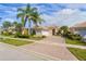 Beautiful one-story home with a brick driveway and lush landscaping, offering curb appeal at 13180 Ipolita St, Venice, FL 34293