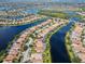 Aerial view of a house and neighborhood with water features at 13180 Ipolita St, Venice, FL 34293