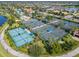 Aerial view of community tennis courts and pool area at 13180 Ipolita St, Venice, FL 34293