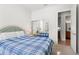 Bedroom with blue plaid bedding and an ensuite bathroom at 13180 Ipolita St, Venice, FL 34293
