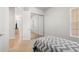 Bedroom with mirrored closet doors and gray bedding at 13180 Ipolita St, Venice, FL 34293