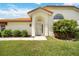 House entrance with lush landscaping and a welcoming front door at 4995 Pepperwood Pl, Venice, FL 34293