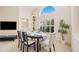 Bright dining room features an oval table with seating for six, and a view to the kitchen at 4995 Pepperwood Pl, Venice, FL 34293