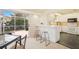 Bright kitchen with white cabinets, granite counters, and stainless steel appliances at 4995 Pepperwood Pl, Venice, FL 34293
