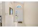 Bright and airy entryway with tile flooring and a mirror at 4995 Pepperwood Pl, Venice, FL 34293