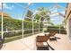 Enjoy the outdoors in this screened patio with comfortable lounge chairs at 4995 Pepperwood Pl, Venice, FL 34293