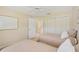Two twin beds in a sunny bedroom with ensuite bathroom access at 4995 Pepperwood Pl, Venice, FL 34293