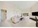 Open living area featuring a comfortable seating arrangement and flat-screen TV at 4995 Pepperwood Pl, Venice, FL 34293