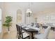 Dining room with table and chairs, view into living room and kitchen at 4995 Pepperwood Pl, Venice, FL 34293
