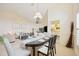 Dining room with a table set for six and an open concept view to the living room at 4995 Pepperwood Pl, Venice, FL 34293