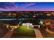 Nighttime aerial view of a canal-front home with well-lit exterior at 45 Bunker Ln, Rotonda West, FL 33947