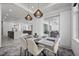 Open concept dining room with modern light fixtures and kitchen views at 45 Bunker Ln, Rotonda West, FL 33947