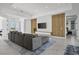 Spacious living room with sectional sofa, wood accent wall, and marble floors at 45 Bunker Ln, Rotonda West, FL 33947