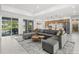 Open living space with sectional sofa and view of the kitchen and pool at 45 Bunker Ln, Rotonda West, FL 33947