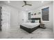 Bright bedroom featuring a gray platform bed, marble floors, and ceiling fan at 45 Bunker Ln, Rotonda West, FL 33947