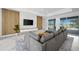 Living area with sectional sofa and sliding glass doors to the pool area at 45 Bunker Ln, Rotonda West, FL 33947