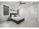 Spacious bedroom with gray platform bed, marble floors and large windows at 45 Bunker Ln, Rotonda West, FL 33947