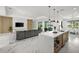 Open floor plan with modern kitchen, living room, and view of backyard pool at 45 Bunker Ln, Rotonda West, FL 33947