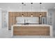 Modern kitchen with a large island, quartz countertops, and wood cabinetry at 45 Bunker Ln, Rotonda West, FL 33947